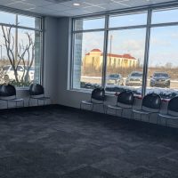 Waiting room with rows of chairs facing large windows