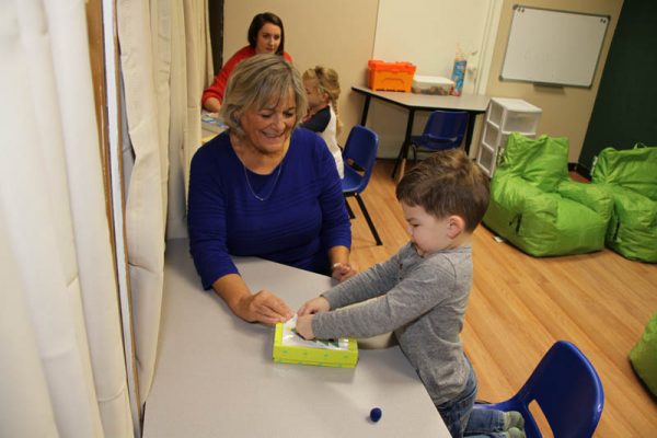 Therapist and a boy working together on a table-top activity