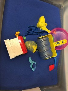 Blue sand with sandbox toys and a play shovel