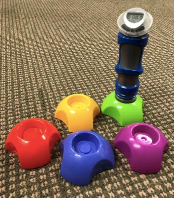 Hyper Dash game with a timed buzzer stacked on a base and colored pods on the carpet