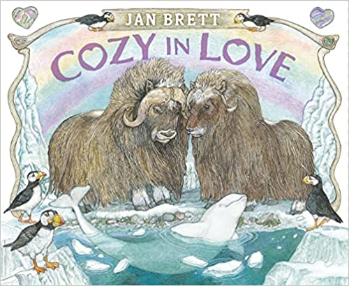 Cover of Cozy in Love by Jan Brett showing two musk oxen touching noses with puffins and a beluga whale